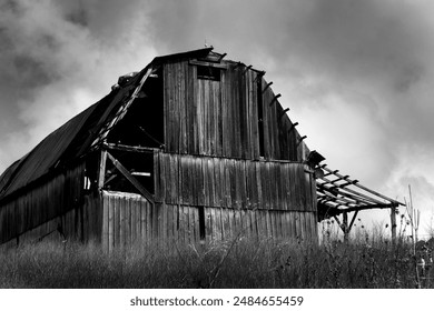 Storm clouds hover over rustic barn in North Carolina.  Image is black and white.