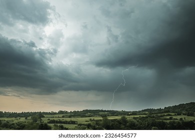Storm clouds and lightning above the countryside