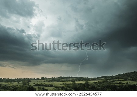 Storm clouds and lightning above the countryside