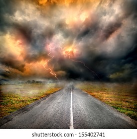 Storm Clouds And Lightning Over Highway In The Field