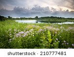 Storm clouds move along the horizon over White Pine Pond at Blackwell Forest Preserve, DuPage County, Illinois.