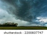 Storm clouds over field, tornadic supercell, extreme weather, dangerous storm