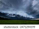 Storm clouds over field, tornadic supercell, extreme weather, dangerous storm, climate change