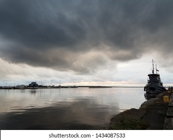 Storm Clouds Over A Historic Tugboat In The Oswego Harbor