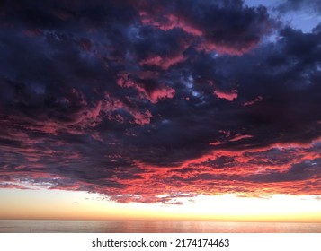 Storm Clouds Over Ocean At Sunset