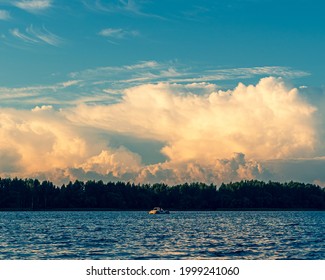 Storm Clouds At Sunset And Catamaran