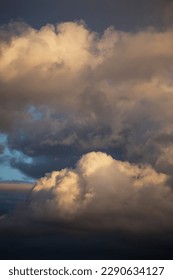 Storm cloudy dramatic sky with dark rain grey cumulus cloud in yellow sunlight and blue sky background texture, thunderstorm, heaven - Shutterstock ID 2290634127