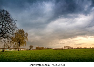 Storm dark clouds over meadow