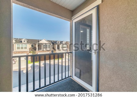 Storm door on the second floor of the building with railing