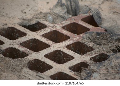 Storm Drain Grate Full Of Mud And Debris