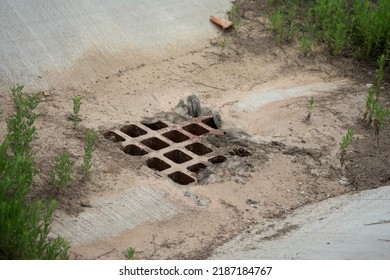 Storm Drain Grate Full Of Mud And Debris