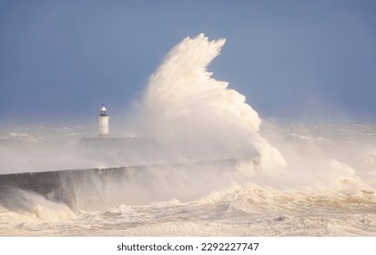 Storm Noa and crashing waves at Newhaven lighthouse and seawall on the East Sussex coast south east England