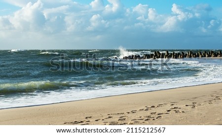 Storm on the North Sea, waves hitting the breakwater concrete tetrapods on the beach, Sylt, Germany