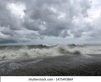 Storm at sea, storm warning on the coast. Thunderclouds and big sea waves during a storm. - image - Shutterstock ID 1475493869