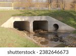 Storm sewer - a concrete culvert under the street.Storm sewer (and drainage) also called the "Stinky River". Concrete culvert (bridge) under the road - street in the outskirts of the city.