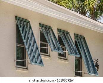 Storm shutters on side windows of a single-family house in west central Florida, USA, for themes of ventilation, climate, hurricane preparedness