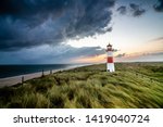 Stormclouds at Lighthouse in List on the island of Sylt, Schleswig-Holstein, Germany