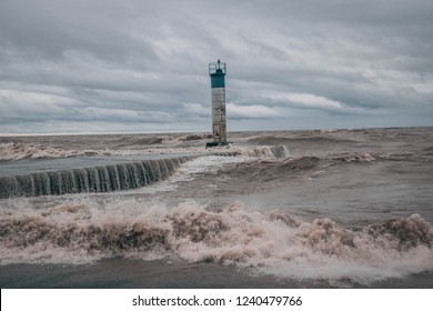 A storming blowing in off of Lake Erie Ontario Canada; Port Bruce Pier getting crashed in to by the rough waters and waves of the great lake;