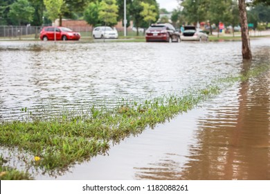 Stormwater Flooding A Road With Stalled Cars In The Background