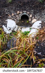 Stormwater Management, Outlet Pipe For Excess Rainwater, Sandbags, And Garden Plantings
