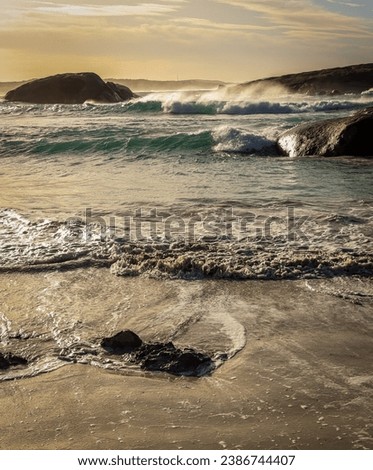 Stormy beach scene with high tide and islands in the background. Esperance Western Australia.
