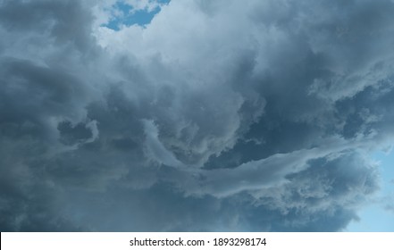 Stormy clouds in a blue sky with complex shapes