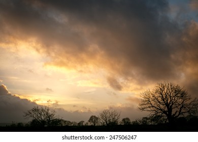 Stormy clouds as the sun sets over the countryside - Powered by Shutterstock