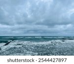 stormy cloudy seascape, waves at the sea, rainy clouds