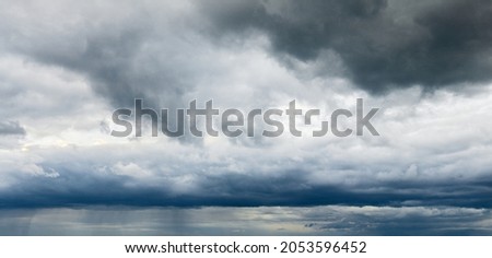 Stormy cloudy sky wide panorama, dramatic dark blue thunderclouds, gale cloudscape, gray cumulus rain clouds panoramic view, thunderstorm heaven landscape, overcast cloudiness weather, hurricane skies