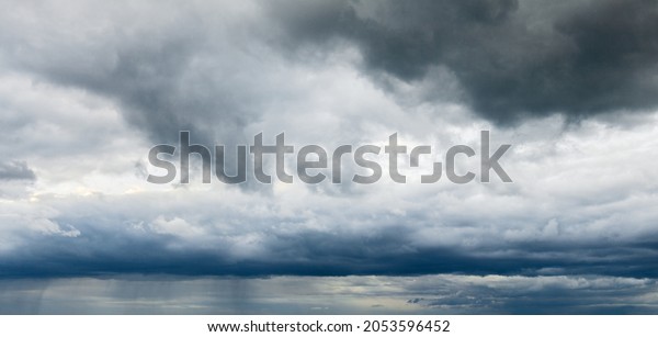 Stormy cloudy sky wide panorama, dramatic dark blue\
thunderclouds, gale cloudscape, gray cumulus rain clouds panoramic\
view, thunderstorm heaven landscape, overcast cloudiness weather,\
hurricane skies