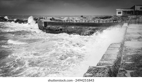 Stormy coastal landscape with stone fortifications and breaking waves. Alexandria, Egypt. Black and white photo panorama - Powered by Shutterstock