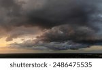 Stormy cumulus clouds forming during heavy thunderstorm on dark sky. Moving and changing cloudscape weather