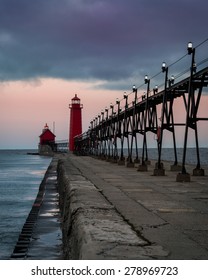 Stormy dawn at the Grand Haven South Pierhead Inner Light with Entrance Light in background in Grand Haven State Park in Grand Haven, Michigan