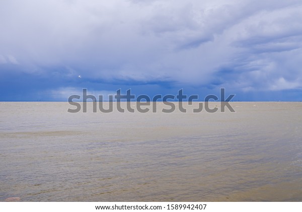 stormy sea in the picture divided by sea and sky\
exactly in half
