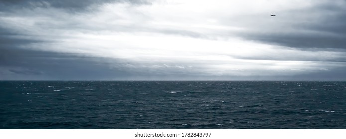 Stormy Sea And Sky With Airplane Facing Strong Wind