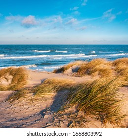 Stormy Sea with waves rolling in, sand is blown over the beach - Powered by Shutterstock