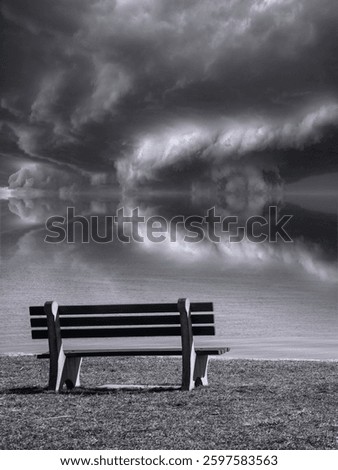 Stormy seascape with two empty benches, a dramatic cloudscape in the Atlantic Ocean