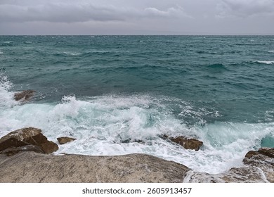 Stormy seaside waves crashing on rocky shore – powerful nature during southern wind