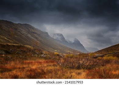 Stormy sky and fog in mountains. Autumn in tundra. Red and yellow autumn meadow landscape in Lapland with river and lake. - Powered by Shutterstock