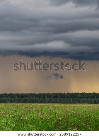 Stormy sky with a large cloud in the middle. The sky is dark and gloomy, and the clouds are heavy with rain. Concept of impending doom and a feeling of unease
