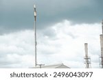 Stormy sky over old gas flare or flare stack with guy wires cables to holding up, exhaust fumes from crude oil refinery plant in San Antonio, Texas, major source air pollutants refined petroleum. USA