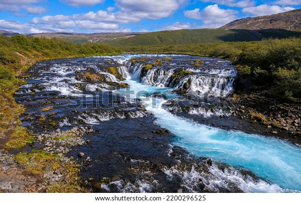 A stormy\
stream in a river valley. River valley landscape. Mountain river\
valley landscape. River stream in\
valley