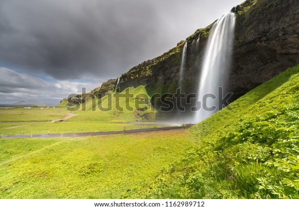 A
stormy summer view of the beautiful waterfall Seljalandsfoss, a
popular stop on Iceland's Golden Circle tourist
route.