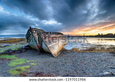 Stormy sunrise over abandoned fishing boats at Salen on the Isle of Mull in Scotland