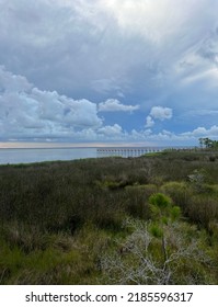 Stormy Sunset Skies Over Natural Preservation Area With View Of Bay Water