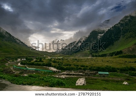 Stormy weather, cloudy sky and dramatic scenic beauty of Himalayan mountains , green mountain valley, way to Kargil from Srinagar, Jammu and Kashmir, India.