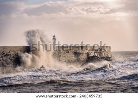 Stormy weather in Newhaven, East Sussex, England in autumn. View of the jetty and the lighthouse.
