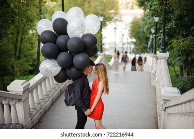 Story Of A Beautiful Loving Couple With Black Balloons, Coming Up The Stairs And Smiling