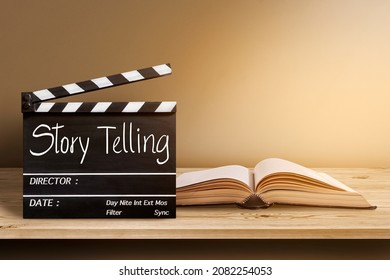  Story Telling.Text title on film slate and old book on wooden background.