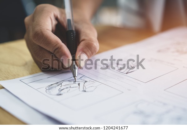 Storyboard or storytelling drawing creative for\
movie process pre-production media films script for video editors,\
Student hand writing graphic organizer in form of illustrations\
displayed in\
sequence